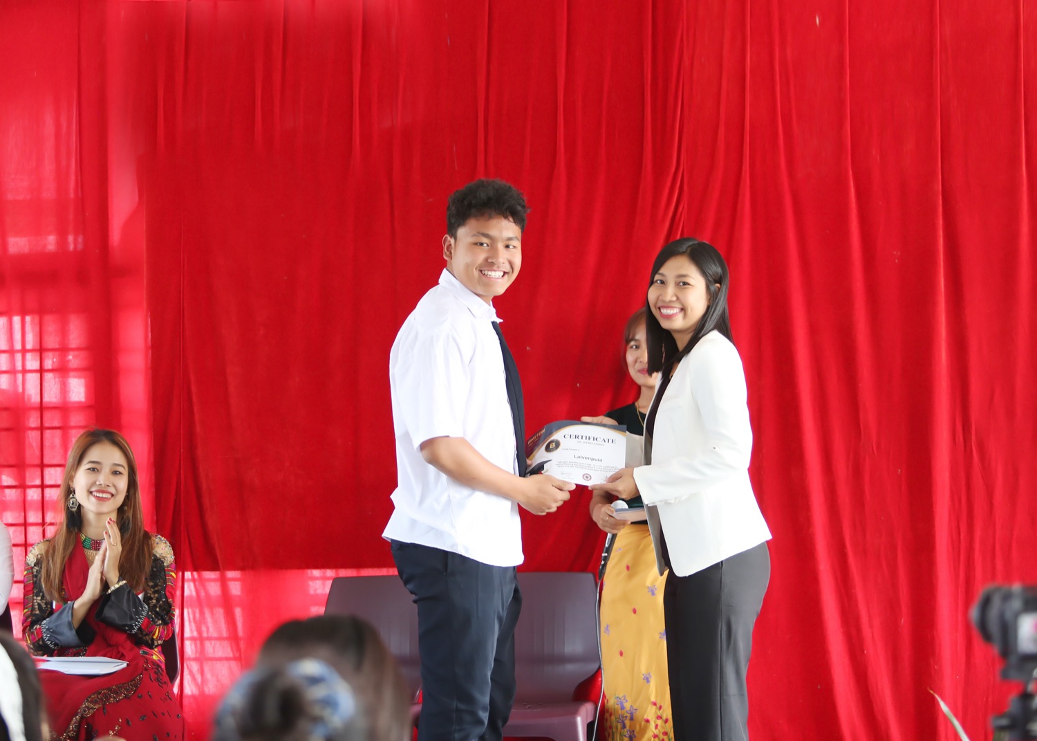 An EPS student receiving a certificate
